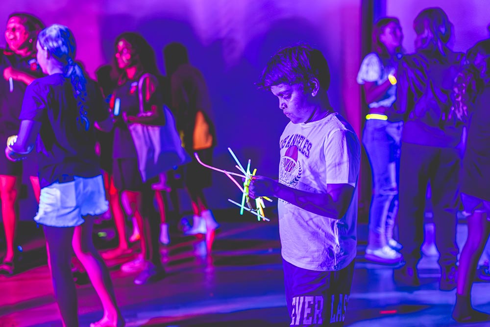 Group of students dancing with glow sticks