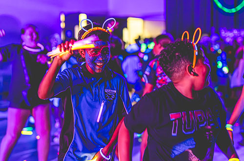 Group of students dancing with glow sticks