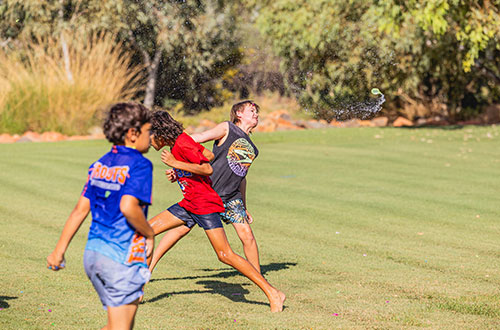 Boys playing sport on an oval