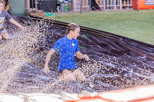 Young girl on a slip and slide
