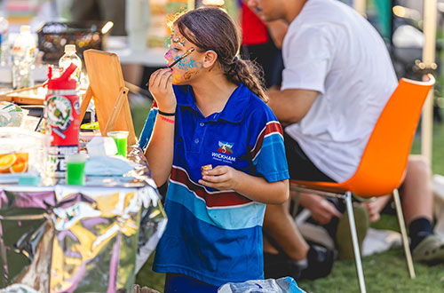 Young girl painting her face